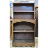 An early 20th century oak, floorstanding open bookcase of stepped form in the art deco style, with