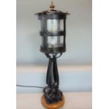 Arts and crafts wrought iron post lantern, with finial and riveted detail, scrolled cabriole