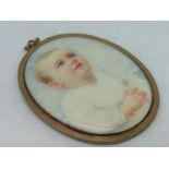 G Bell (early 20th century British school) - Half length miniature portrait of a blue eyed baby in