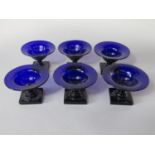 A good quality set of six blue glass sweet meat glasses, the flared rims on turned stems and