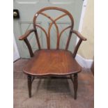 A Georgian Windsor elbow chair, principally in elm and beech, the hoop back with Gothic tracery