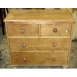 A small Victorian stripped and waxed pine bedroom chest of two short over two long drawers on turned