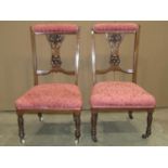 A pair of inlaid Edwardian mahogany low drawing room chairs, with upholstered seats and back