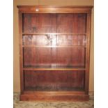 An Edwardian floorstanding open bookcase with three adjustable shelves over a moulded plinth and