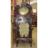 An Edwardian mahogany side cabinet with raised and shaped back enclosing a bevelled edge shield