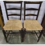 A set of five stained beechwood low ladderback chapel chairs with rush seats, raised on simple