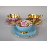 Three Aynsley cabinet cups and saucers, one with fruit decoration in the Royal Worcester style,