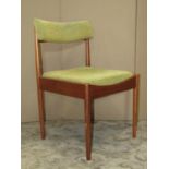 A set of four mid-20th century teak framed dining chairs with light green upholstered drop-in