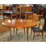 A mid-20th century teak D end extending dining table with single bi-fold leaf, raised on tapered and