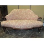 A Victorian drawing room sofa of small proportions, with carved walnut show wood frame, the shaped