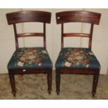 A pair of Chippendale style dining chairs with pierced Gothic tracery splats over drop-in