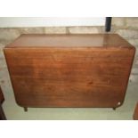 A Georgian mahogany drop-leaf table fitted with one real and one dummy frieze drawer raised on