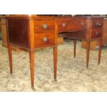 An inlaid Edwardian shallow inverted breakfront knee hole dressing table, with boxwood stringing,