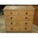 A Victorian stripped pine bedroom chest of two short over three long graduated drawers raised on