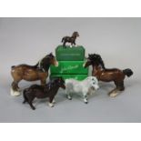 A collection of Beswick animals comprising a grey Shetland pony, a brown Shetland pony and a