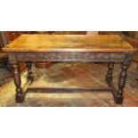 A 19th century oak refectory table in the 17th century manner, the heavy plank top, raised on four