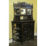 A small aesthetic movement side cabinet, the central lower section enclosed by two carved and