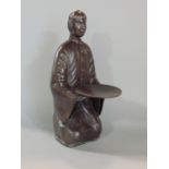 Bronze study of a Chinese attendant holding a charger (possible pin tray) 23cm high