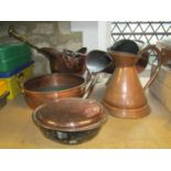 A 19th century copper helmet shaped coal scuttle, one other, a circular copper two handled pan, 19th