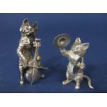 Pair of cast silver figures of casts playing musical instruments, one on the cymbals, the other