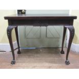 A good quality Edwardian mahogany fold-over top card table of rectangular form, with carved blind