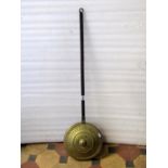 A 19th century brass warming pan with pierced dome cover and steel handle