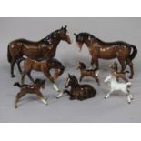 A collection of eight Beswick horses and foals in various poses, all in brown colourway apart from