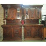 A pair of 19th century oak two sectional buffets, the upper enclosed by three panelled doors, two