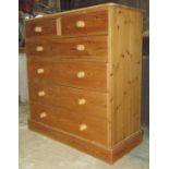 A Victorian style stripped pine bedroom chest of two short over four long graduated drawers and