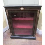 A Victorian pier cabinet with ebonised finish, enclosed by a glazed panel door, with string inlay