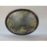 Large Victorian oval tray painted with various country flowers upon a black ground, 77 cm long (AF)