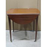 A small 19th century mahogany Pembroke table with oval drop leaves, with one real and one dummy