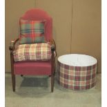 A fireside chair with upholstered seat and arched padded back, over scrolled arms and tapered
