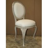 A single chair with sprung upholstered seat and cameo shaped padded back within a painted frame with