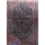 Interesting Persian village rug with repeating geometric medallion and floral decoration upon a navy