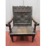 An antique oak Wainscot chair, the panel with geometric floral decoration, the cresting rail with