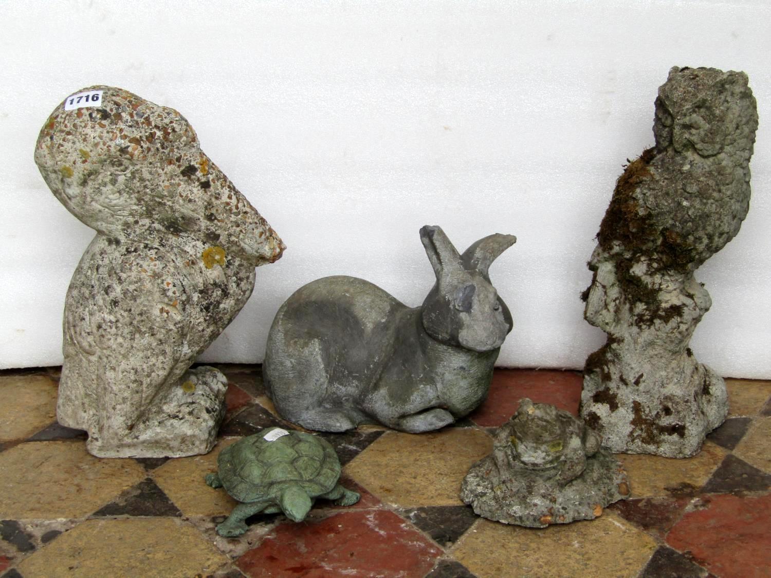 Three small weathered composition stone garden ornaments in the form of a pelican, owl and frog,