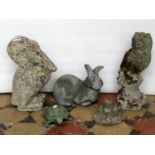 Three small weathered composition stone garden ornaments in the form of a pelican, owl and frog,