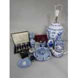 A collection of reproduction oriental blue and white printed wares comprising a large lamp base in
