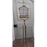 A good Victorian brass bird cage with wire work panels, set upon a brass framework of full height,