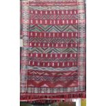 Tribal Kelim rug with various alternating geometric banded decoration upon a deep red and black