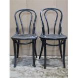 A set of four ebonised Bentwood cafe chairs with circular seats and slightly swept supports