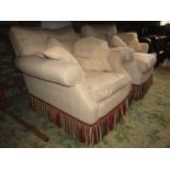 A pair of good quality traditional drawing room chairs with rolled arms, cream ground beige