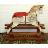 A vintage Feeway child's painted wooden working horse with pine trestle base