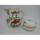 a jug in the Chelsea manner with painted exotic bird decoration on a relief moulded ground and