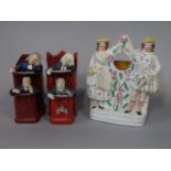 Two 19th century Staffordshire figure groups of the vicar and Moses, one with painted cherub's