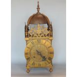 antique style two train brass lantern clock, with typical pierced arched top, with large brass bell,