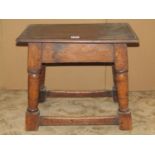 An Old English style oak joint stool, the rectangular top with moulded outline, raised on turned