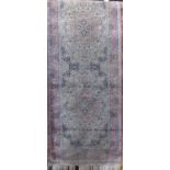 Cashmere type runner decorated with various floral medallions upon a pink ground, 300 x 80cm