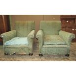 A pair of late Victorian/Edwardian low deep seated country house easy chairs, with scrolled back and